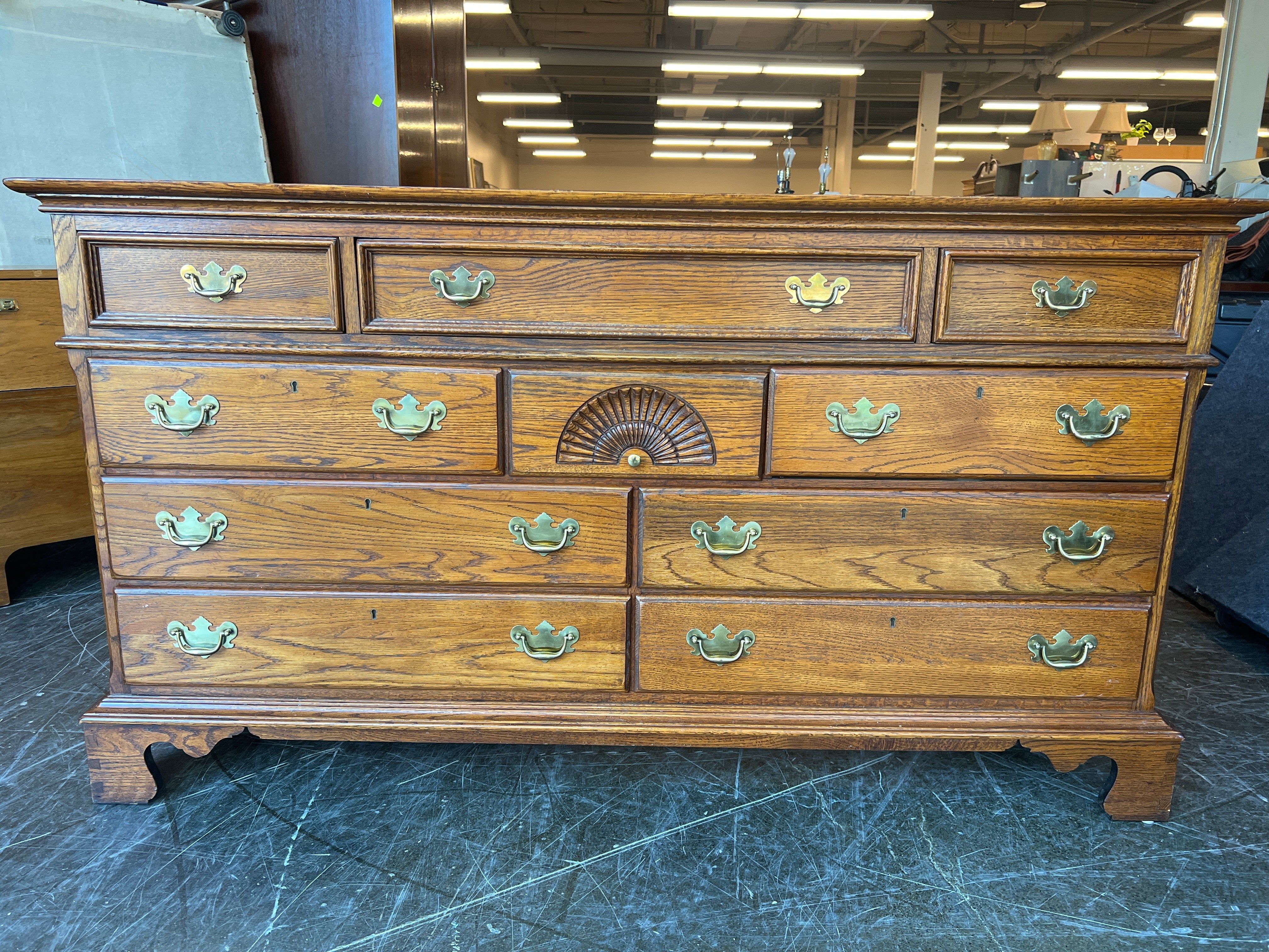 Richly-Toned Wood Dresser with Carved Center Drawer
