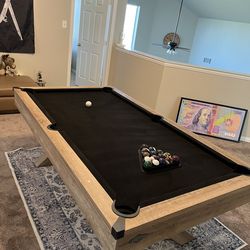 pool table with sticks and custom balls