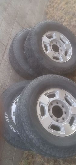4 Chevy HD 8 lug wheels and tires with caps.