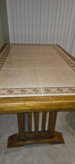 Wooden/tile dinning room table.