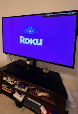 70 inch flat screen mounted to a glass base