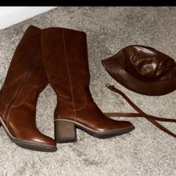 Brown knee-high boots + a matching hat and belt for a stylish look.
