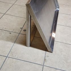 Slanted stainless steel shelf. Commercial wall mount shelf