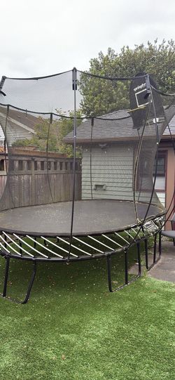 Large Oval Springfree Trampoline, with Basketball Hoop Attachment.