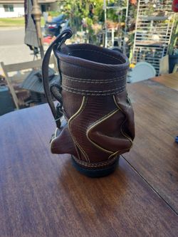 VIntage mini golf bag or "den caddy" made of brown faux leather, often used as a desk organizer, waste bin, or