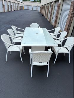 Front-gate white wicker patio dining set with 8 chairs