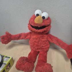 Sesame Street Tickle Me Elmo plush toy. 
