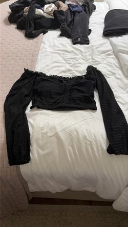 This shirt from the brand papermoon is a size medium with a corset type style and a ruffle pattern on the top.