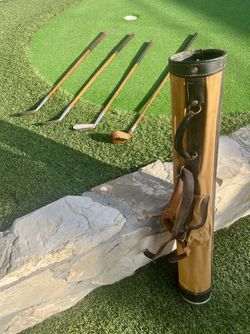 Set of 4 vintage 1920s golf clubs with original bag. Includes Mashie, Driver, Mashie-Niblick, & Putter, marked "Schmelzer’s Sporting Goods,