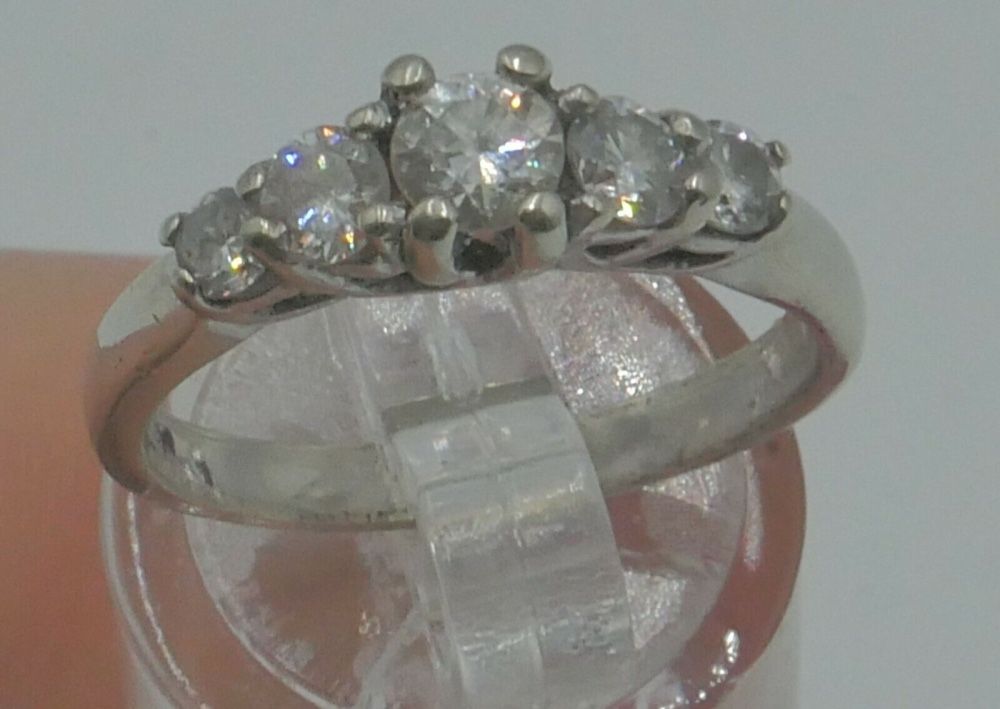 14KT WHITE GOLD ANNIVERSARY BAND SIZE 7.5 3.8 GRAMS WITH 5 DIAMONDS APPROXIMATE CENTER ROUND DIAMOND 0.30 0.35PTS SI2 H; 2 SIDE DIAMONDS 0.16 0.18