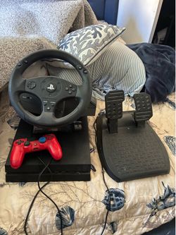 PS4 with controller and steering wheel and pedals