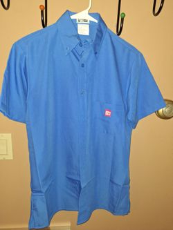 Dunkin' Donuts manager uniform shirt featuring a small logo on the pocket.Authentic manager short sleeve button-down shirtMaterial: Typically a polyes