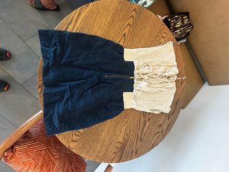Stylist two-tone mini dress with a cream colored lace up