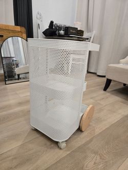 White perforated metal rolling storage cart, 3 compartments, wheels for easy mobility. Great for craft supplies, beauty products, or kitchen storage. 
