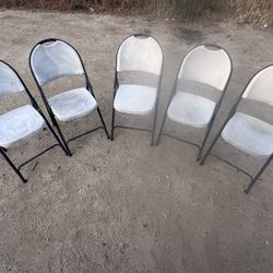 Worn used weather damaged chalky chairs