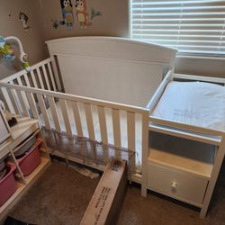 White Baby Crib With Changing Table, Storage Shelf, Drawer and Mattress.