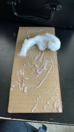 Piece of cardboard glue and cotton