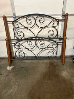 Ornate rod iron and wood qheadboard and footboard
