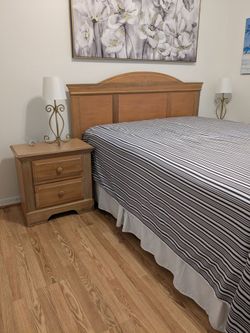 Queen bed with both matching nightstands and new bedspring.