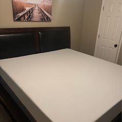 Dark wood bed with mattress