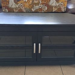 Selling  A Black All Wood T.V. Stand With 2 Front Glass Doors & 2 Level Shelves.Excellent Condition 