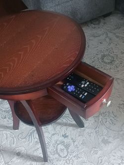 Round accent table with drawer and bottom shelf