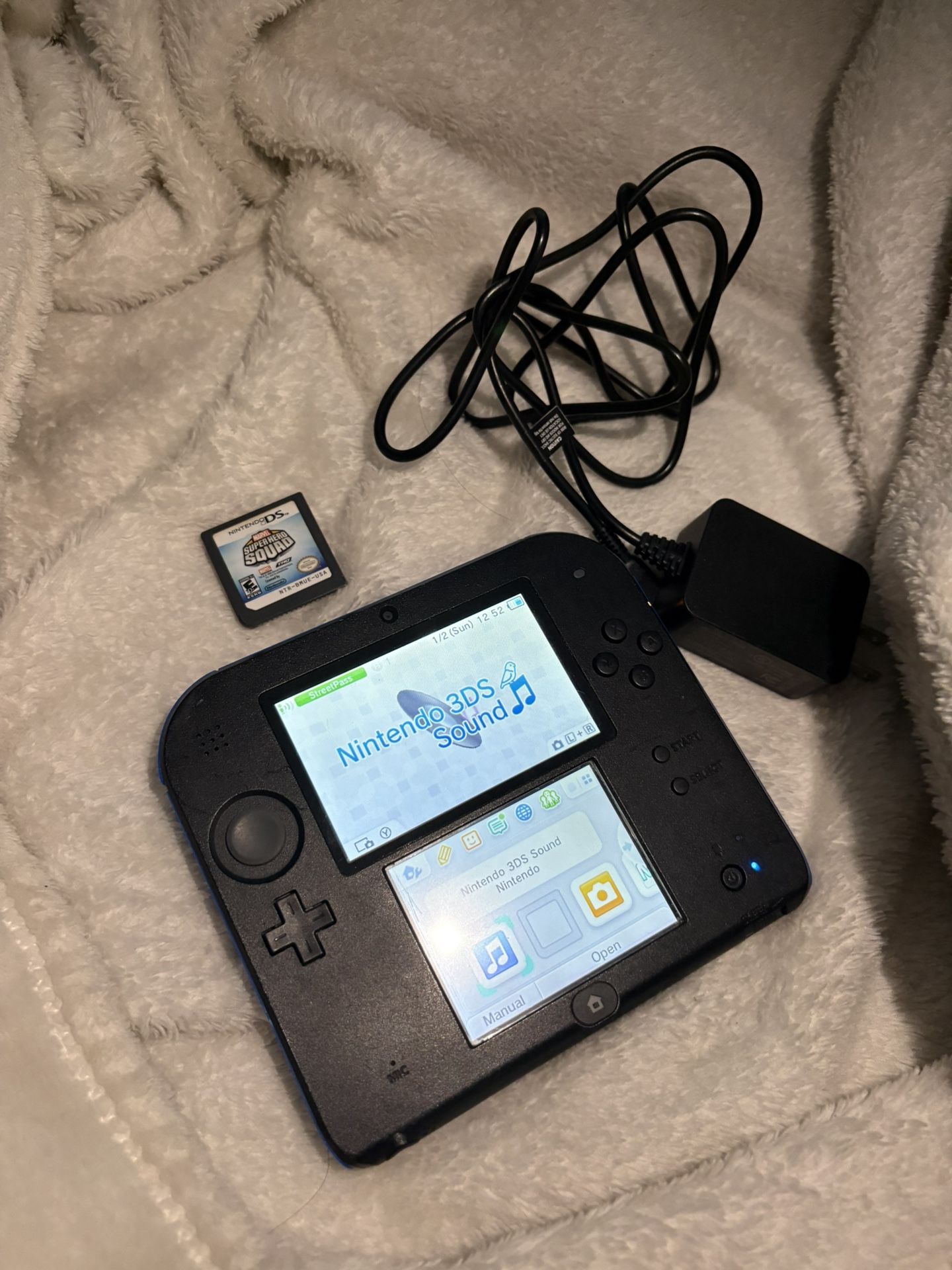 Nintendo 2ds with charger and a game