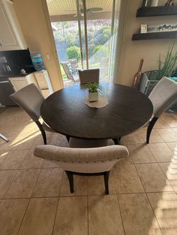 Gray round kitchen table and chairs