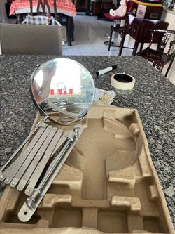 Extendable wall-mounted mirror with a magnifying side; the mirror measures 6 1/2 inches.