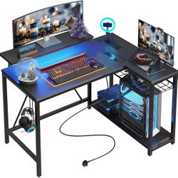 Bestier Gaming Desk with Power Outlets, 42" L-Shaped Computer Desk with LED Lights, Desk with Reversible Storage Shelves & Hooks for Small Spaces, Bed
