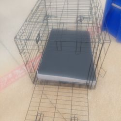 A Medium Dog Crate With Dog Padding