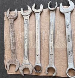 Five-piece wrench lot featuring a mix of open-end and combination wrenches from several manufacturers.