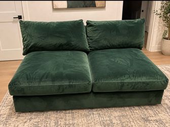 Living Spaces green velvet armless sofa