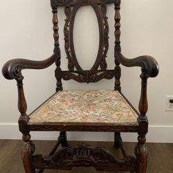 A carved walnut Baroque-style armchair with tapestry seat.
