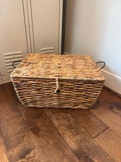 Woven Wicker Storage Basket with Flip Lid and Metal Handles.