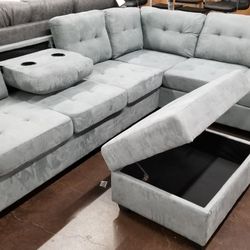 Light gray fabric reversible sectional with a matching storage ottoman