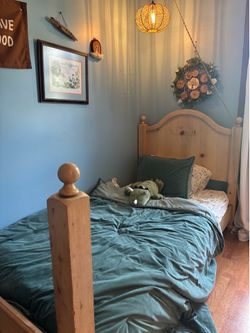 Solid wood twin bed with mattress, mattress topper, and water proof cover