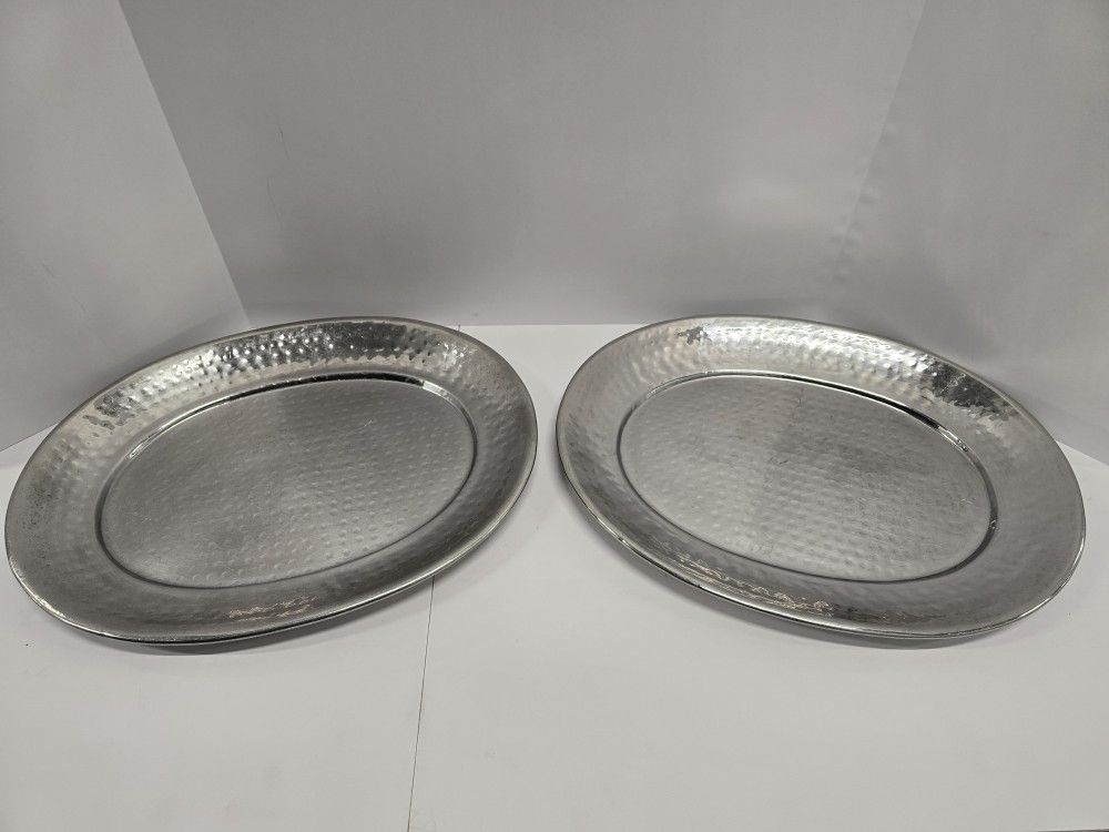 set of two hammered silver-tone oval serving trays. The hammered finish adds texture and shine