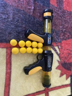 Toy Gun With Yellow Balls As Bullets