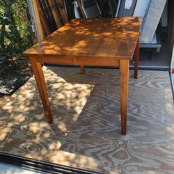 Real wood dining room table it has a metal piece that can become bigger