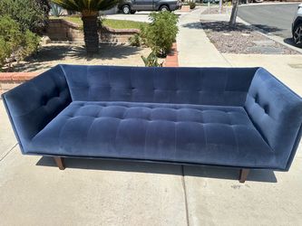 Tufted blue velvet sofa