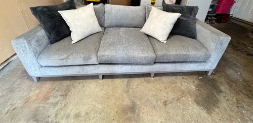 Brand new gray sofa with pillows