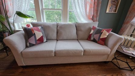 Light gray couch with decorative pillows