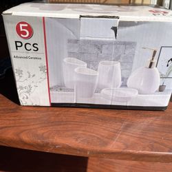 5-piece ceramic bathroom accessory set including soap dispenser, soap dish, toothbrush holder and cups.