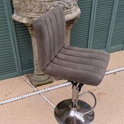 Plush gray suede swiveling bar stool/island chair