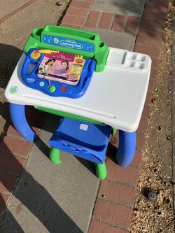 Child table and chair with book pad and books
