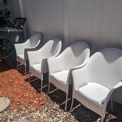4 Matching White Hard Plastic Outdoor Chairs. Could Use A Deep Clean But In Good Condition 