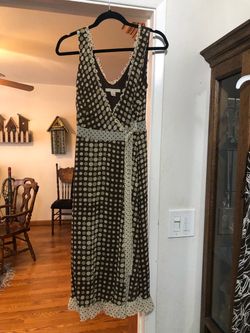 Women’s Size 8 VNeck Sleeveless Wrap Around Dress .  With tie front. Length mid-calf.  Colors brown and beiges.  Preowned Good Condition.