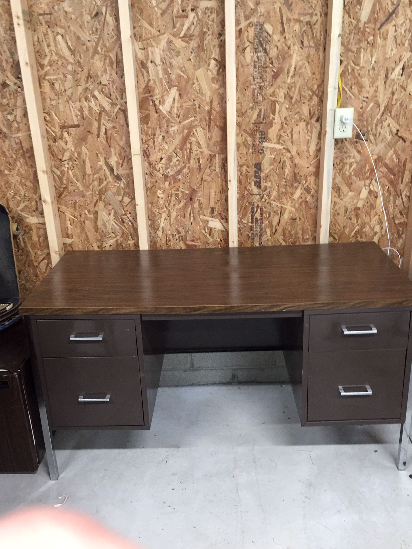 Desk with five drawers. Two are hanging file cabinet at drawers.