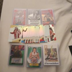 Two Signed WWE Wrestling Cards Along With A Stack Of Wrestling Cards And Some Numbered Cards 